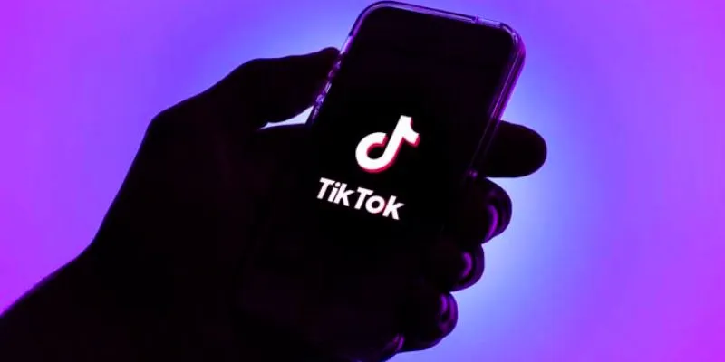 A group of diverse people using TikTok on their smartphones